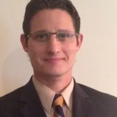Mike Styke, in a suit and tie, with glasses